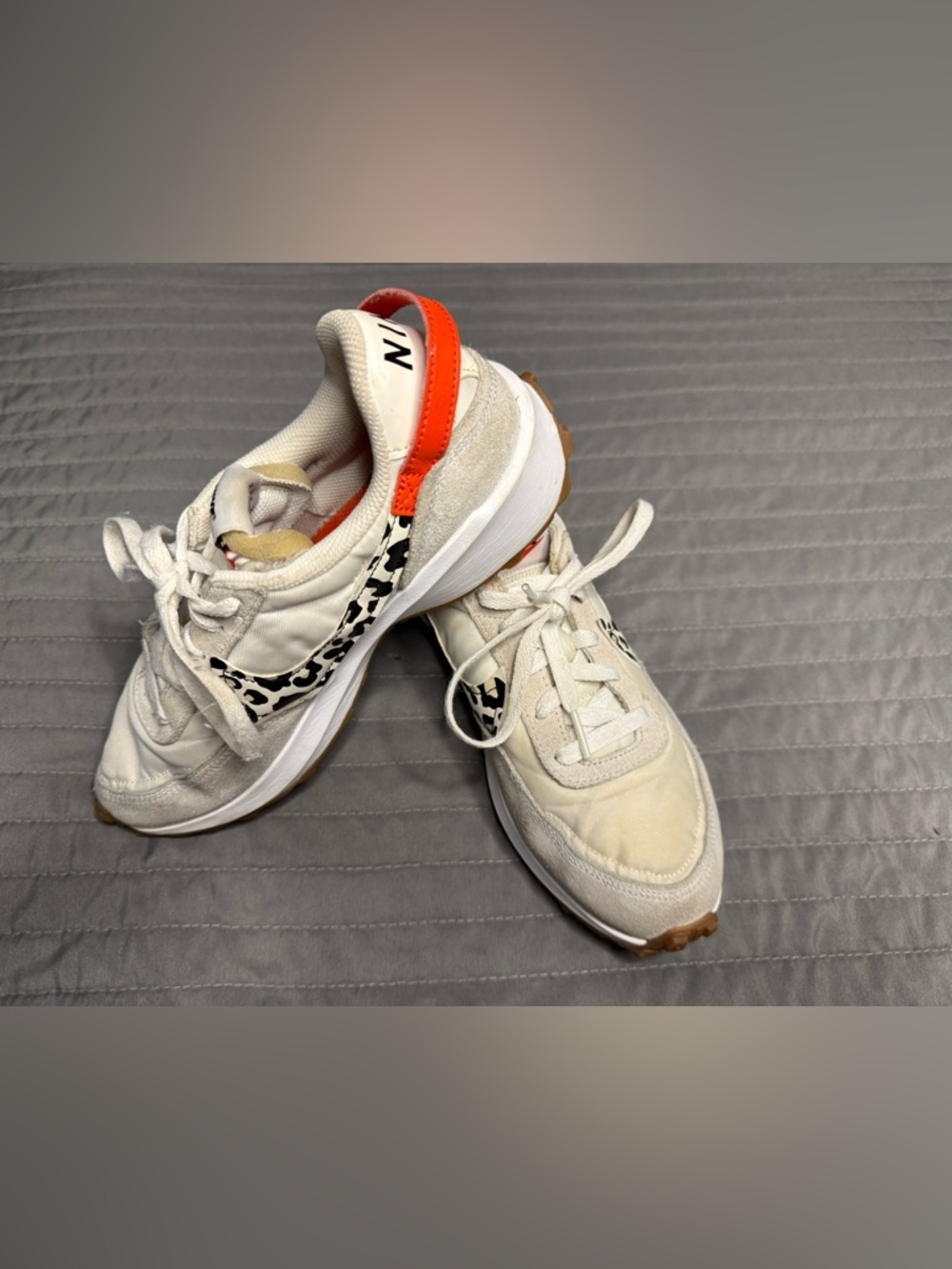 White Nike Sneakers with Black Leopard Swoosh and Orange Heel Tab